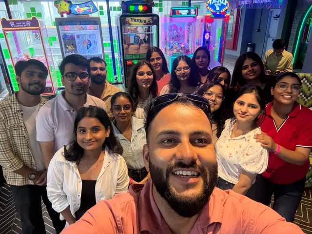 A group selfie of the Uhire team at the arcade