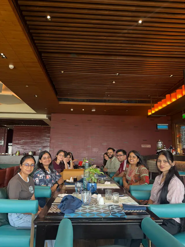 The team seated around the lunch table