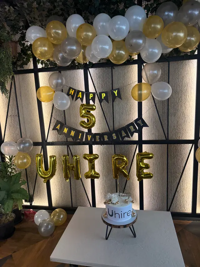 Gold balloons spelling Uhire for the 5th anniversary