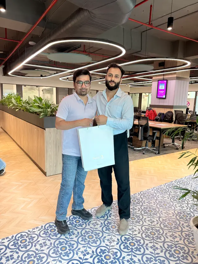 The founder gifting a MacBook to another manager